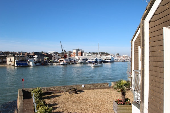 Guests can enjoy stunning waterfront views from the balcony of this marina-side accommodation.