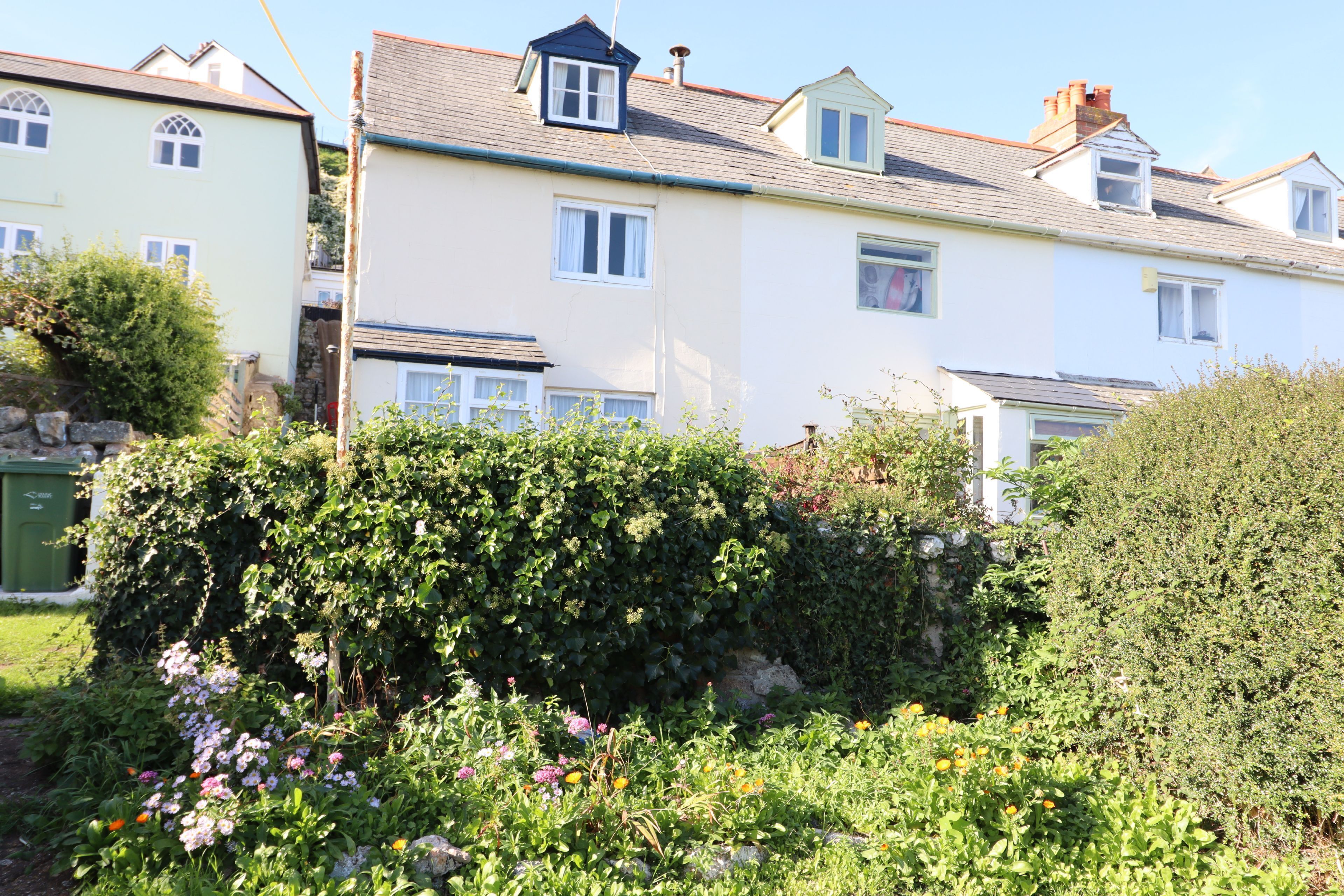 A row of houses with a garden in front.