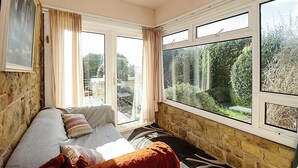 A room with a bed, a window, and a view of the outdoors.