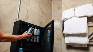 A minibar with various beverages and a towel rack with folded towels. - Brewdog Kennels Aberdeen (Aberdeen)