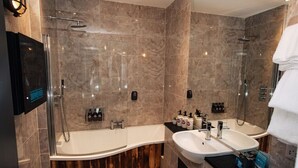 A modern bathroom with a glass-enclosed shower, a freestanding bathtub, and a vanity with a sink. - Brewdog Kennels Aberdeen (Aberdeen)