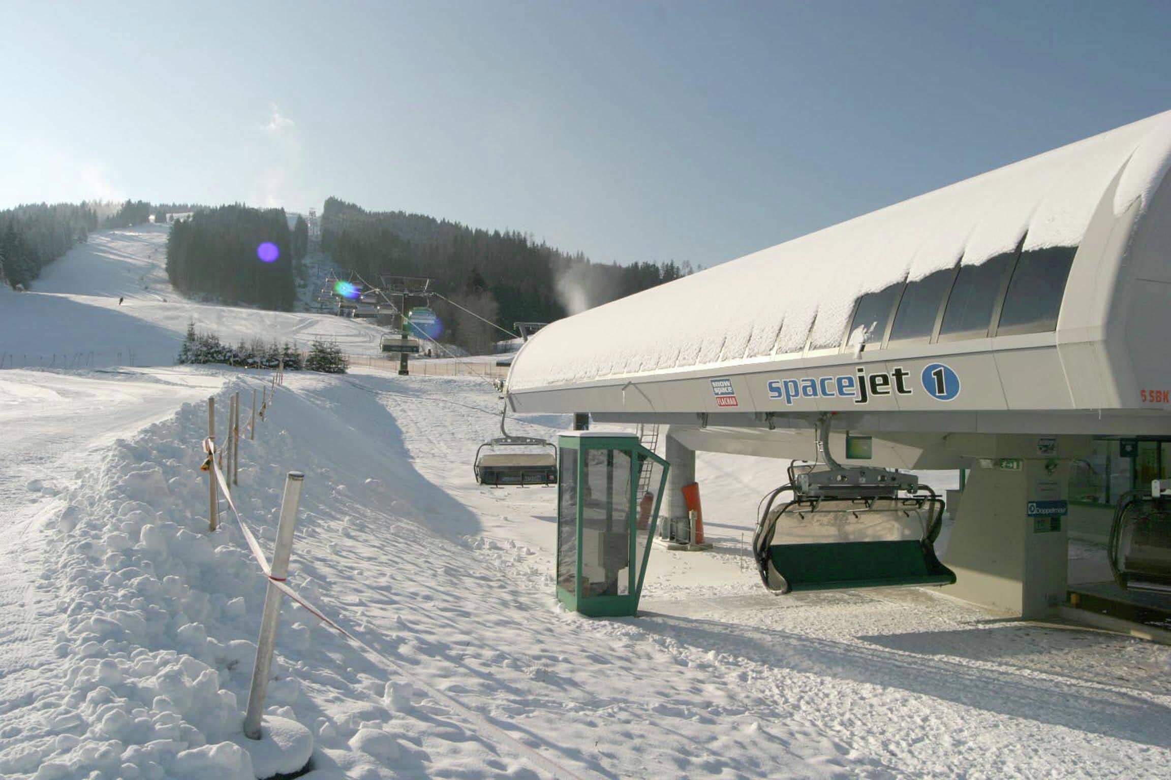 A snow-covered ski slope with a SpaceJet terminal.