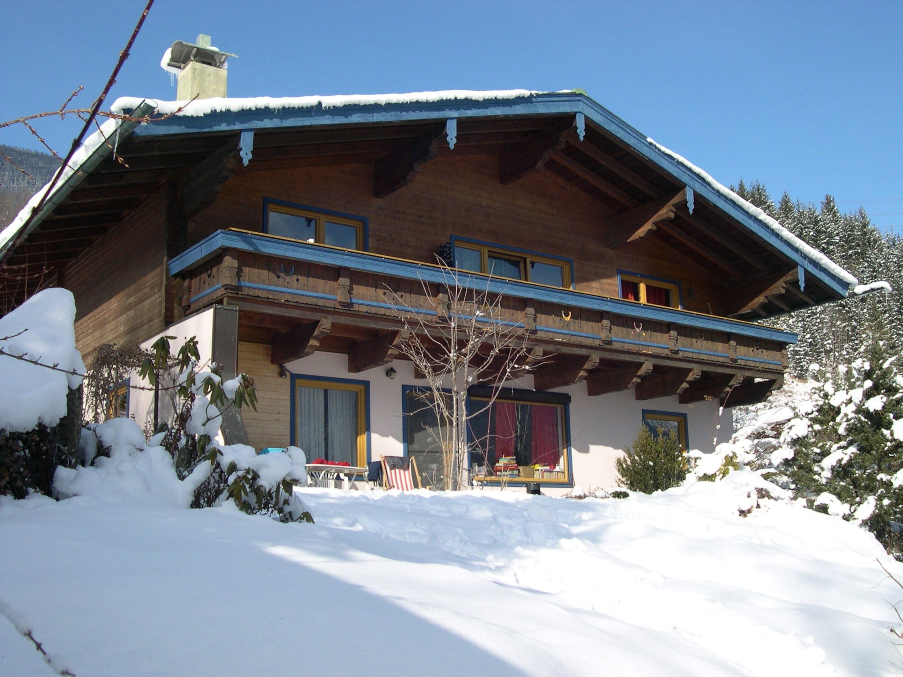A wooden chalet with a sloped roof and a balcony.