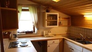 A compact kitchen with a stove, sink, and cabinets. - Large Holiday Home With Plenty of Privacy (Flachau)