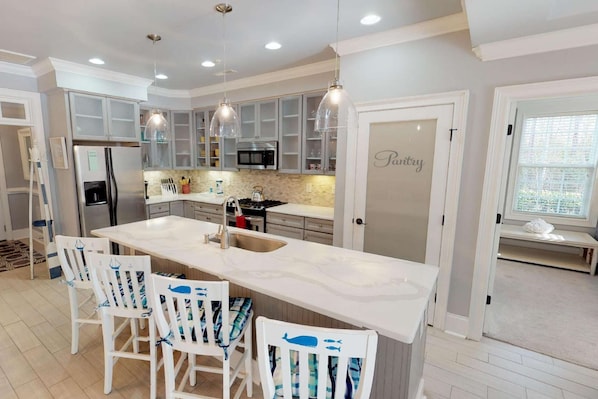 A modern kitchen with a large island, white cabinetry, and pendant lighting. - *Fall into Savings-20% Off New Bookings thru 2026* (Murrells Inlet)