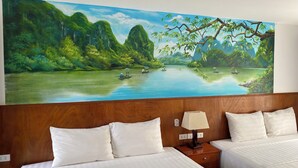 A hotel room with two beds, a nightstand with a lamp, and a large painting of a river landscape on the wall. - Elizabeth Hotel Tam Coc (Nam Hoa Lu)