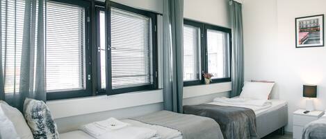 Hypo-allergenic bedding, desk, laptop workspace, blackout curtains