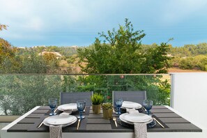 A table set for two with a view of the landscape.