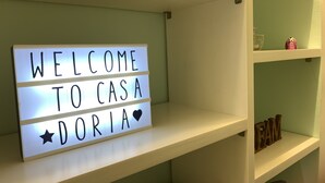 A lighted sign with "WELCOME TO CASA DORIA" on a shelf. - Casa Doria - Vatican Museums (Roma)