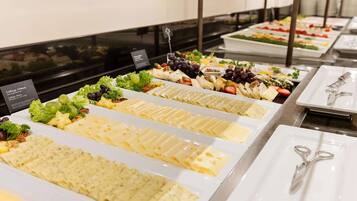 A buffet with various cheese and salad options.