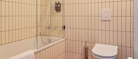 A bathroom with a glass-enclosed shower, a toilet, and a towel rack.