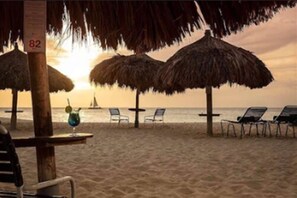 On the beach, white sand, free beach cabanas, beach umbrellas