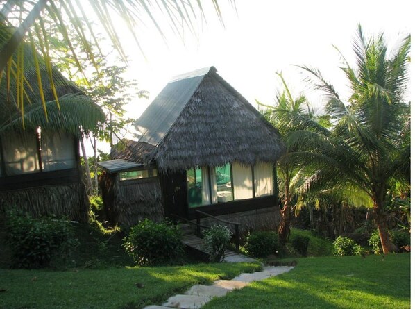 Surrounded by lush greenery, this traditional bungalow offers a serene retreat.