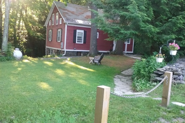 Front Lawn, stone walkway, Front Door behind tree.