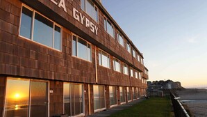 A multi-story building with the name "SEA GYPSY" on its facade.