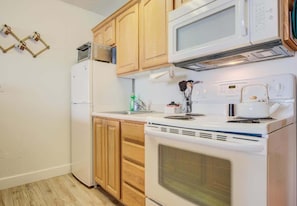 Enjoy cooking in this fully equipped kitchen with a microwave, refrigerator, and coffee maker.