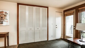 A room with a large closet, a desk with a lamp, and a window with blinds. - Stunning Views, Closest to Mt. Bachelor, Resort Amenities & Year-Round Fun! (Bend)