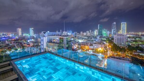 A rooftop pool with a cityscape view at night. - Seahorse Tropical Natalie Da Nang Hotel by Haviland (Da Nang)
