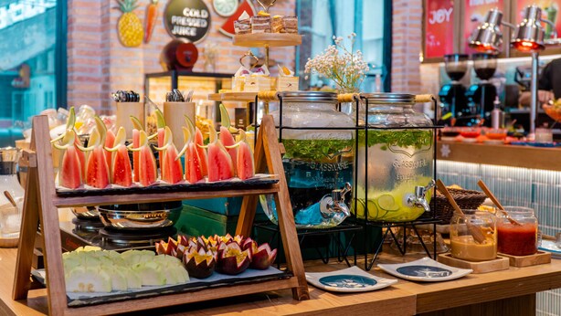 A buffet with various food items and a large beverage dispenser. - Seahorse Tropical Natalie Da Nang Hotel by Haviland (Da Nang)
