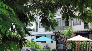 A building with a sign reading "Le Petit" and a black car parked in front. - Le Petit Villa Hoi An (Da Nang)