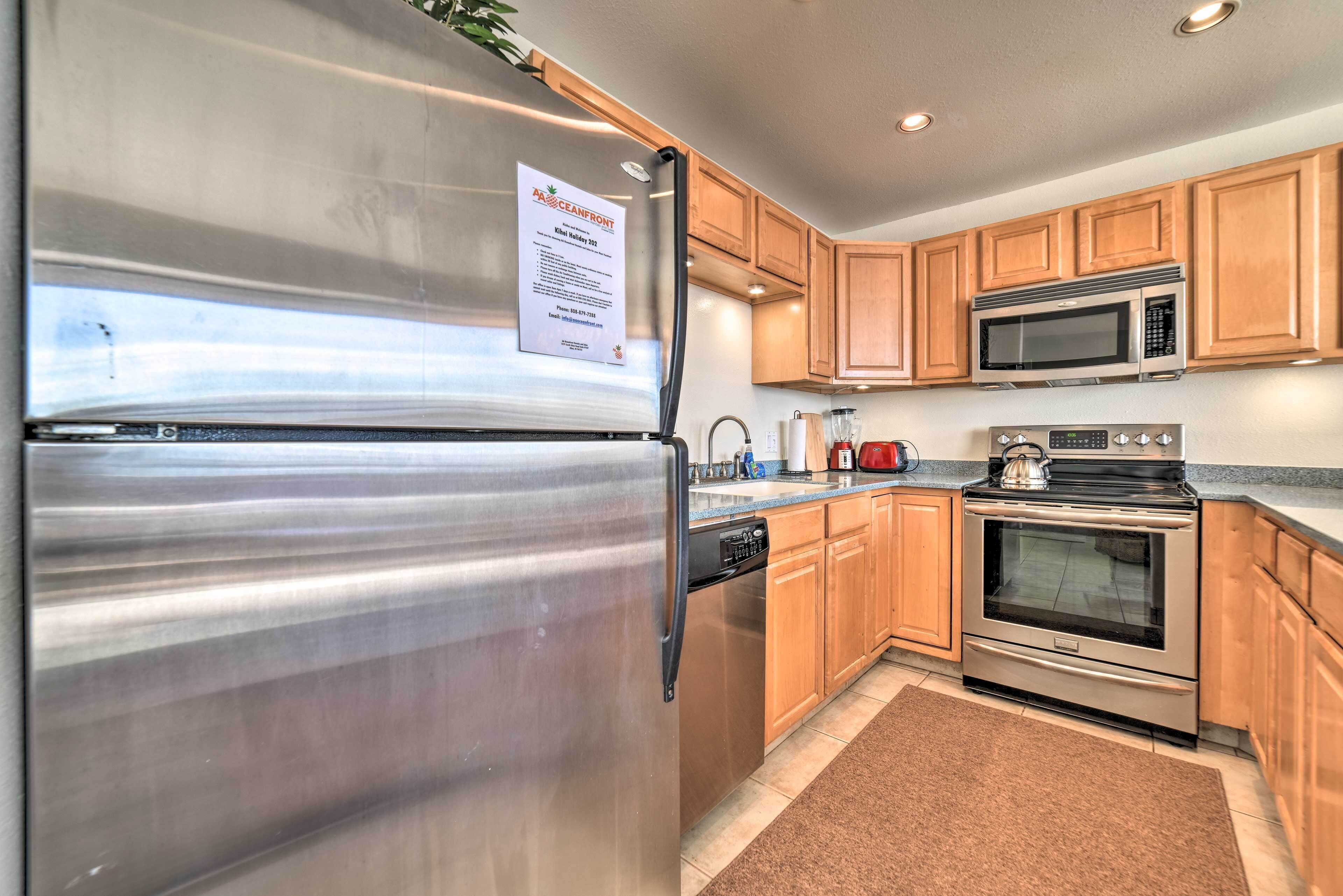 A modern kitchen with stainless steel appliances, wooden cabinets, and a built-in microwave.