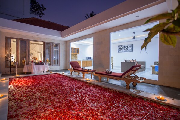 Relax in a serene outdoor space with a patio, lounge chairs, and a modern interior view.