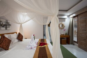 Relax in a spacious room with a large bed, desk, and seating area.