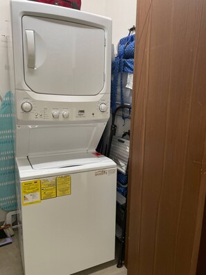 A compact washer and dryer unit with control knobs and a label indicating energy efficiency. - Romantic Zone Gem | 2 Pools, Gym | Walk to Beach (Puerto Vallarta)