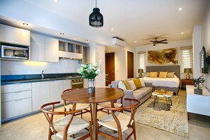 A modern apartment with a kitchen, dining area, and living room.