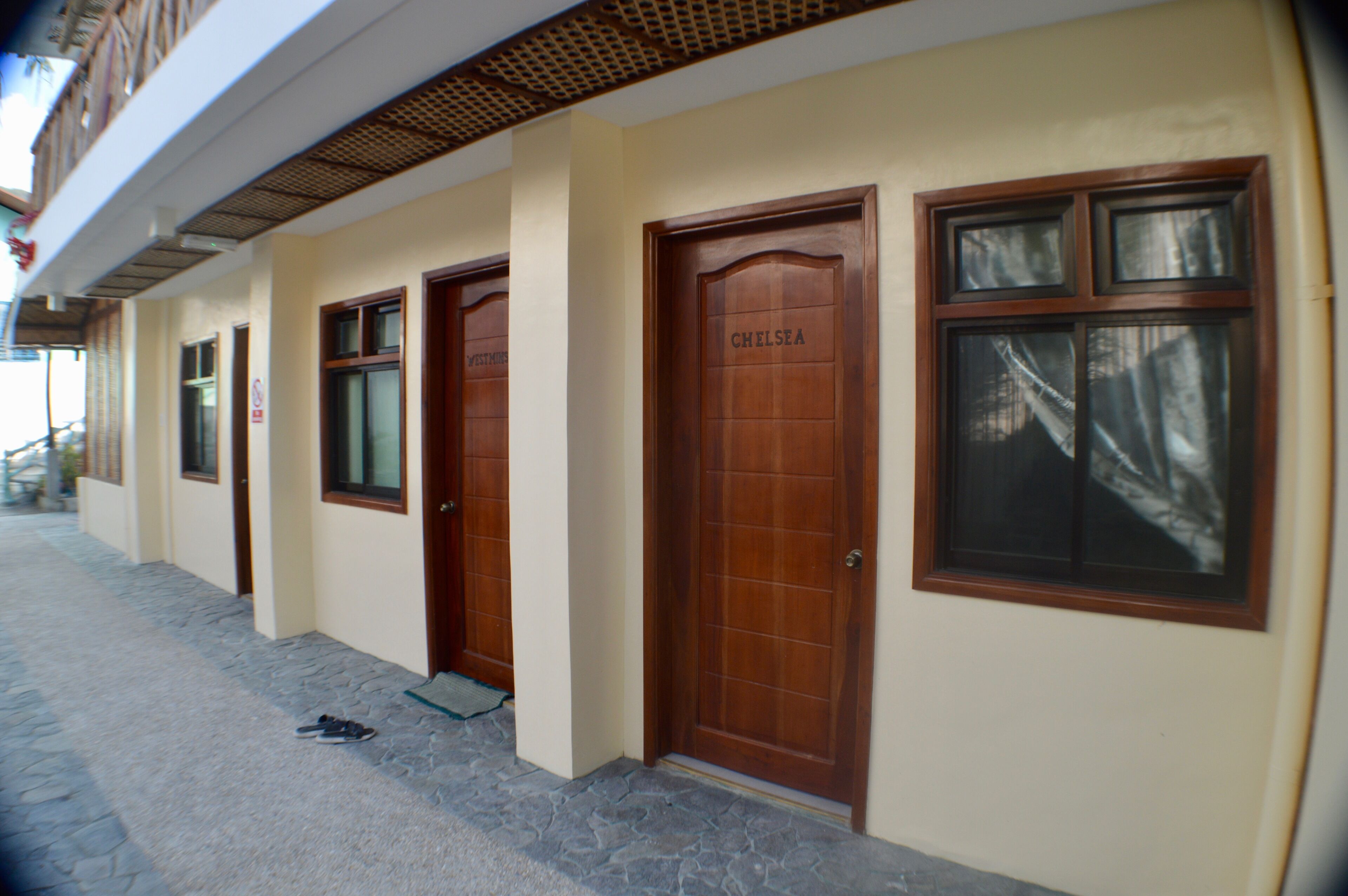A building with three wooden doors, each with a window above.