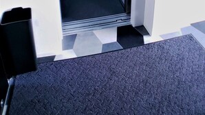 An elevator with a metallic control panel and a grey interior. - Ocean View Araha 201 (Chatan)