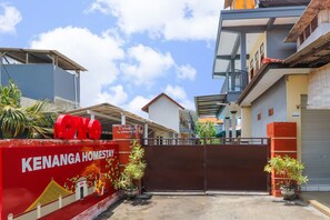 A gated entrance to a residential complex with a red sign reading "KENANGA HOMESTAY". - Hotel O Kenanga Homestay (Nusa Dua)