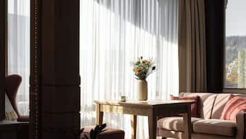 Una sala de estar acogedora con una mesa de madera, un banco acolchado y un sofá.