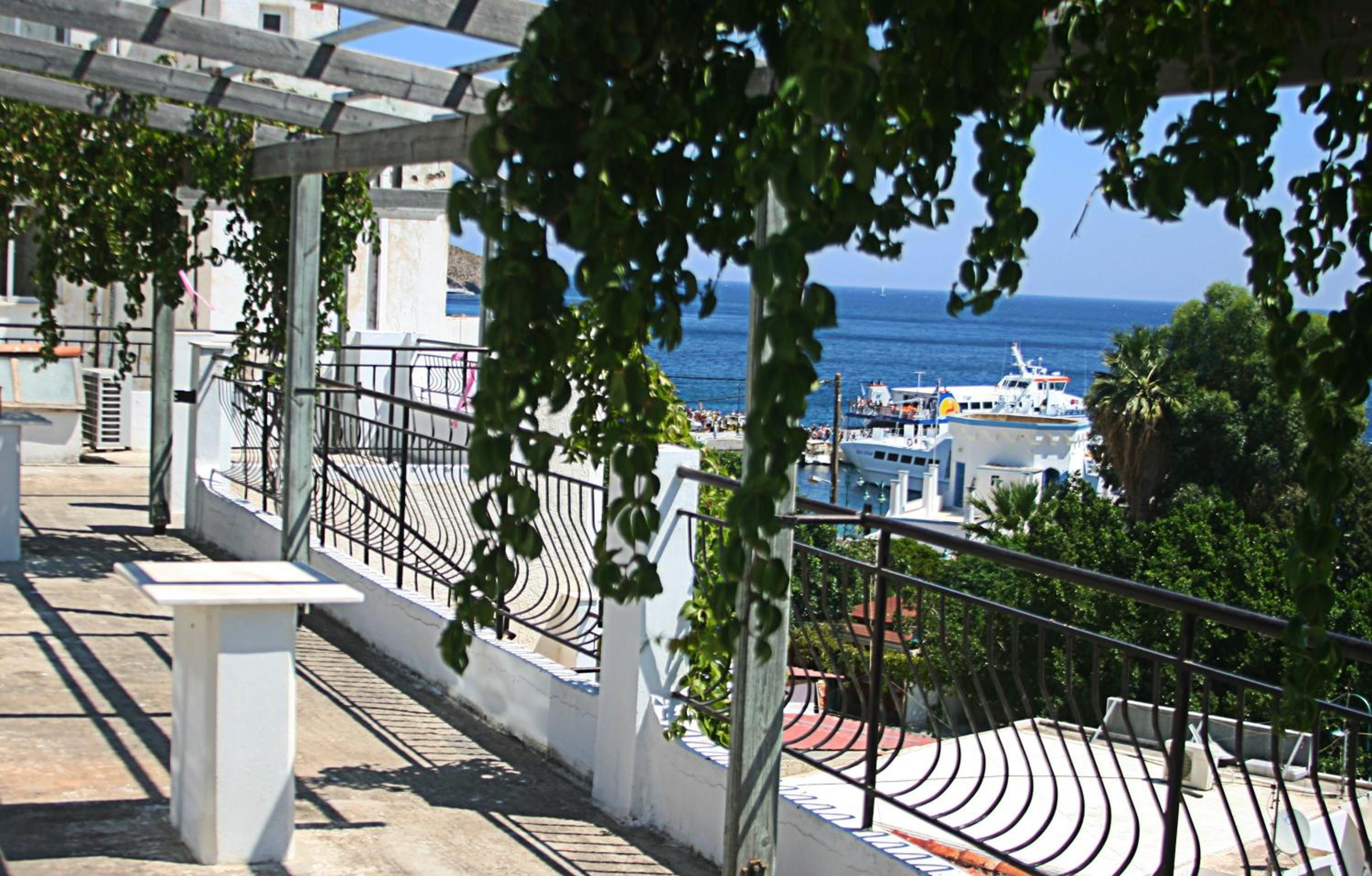 A balcony with a view of the sea and boats.