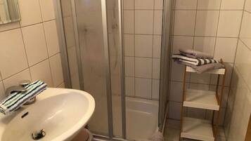 Shower, hair dryer, towels, toilet paper