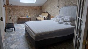 A bedroom with a bed, a chair, a small table, a hanging light fixture, and a skylight. - COMPLETE AUTHENTIC QUIET & HEALTHY HOUSE WITH PICINE 10x4m = 100% YOURS (Saint-Martial)