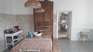 A dining area with a wooden table, chairs, a bowl, and a coffee maker. - COMPLETE AUTHENTIC QUIET & HEALTHY HOUSE WITH PICINE 10x4m = 100% YOURS (Saint-Martial)
