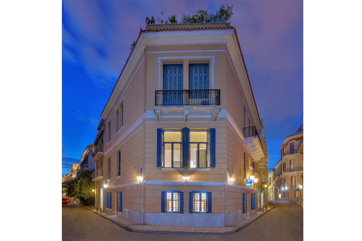 A corner building with a balcony and multiple windows.