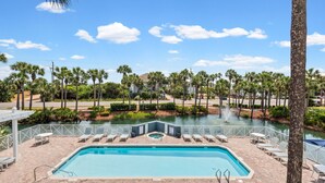 A swimming pool with lounge chairs, a water feature, and palm trees. - Modern Updates, 1 Minute to the Beach!  + Free Attraction Tickets! (Santa Rosa Beach)