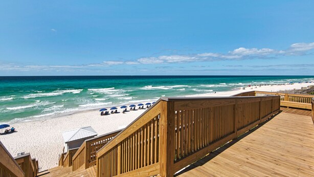 A wooden boardwalk leading to a beach with white sand and ocean waves. - 1st Floor, Gulf Side, Lagoon Pool, Beach Chair + Free Attraction Tickets! (Panama City Beach)