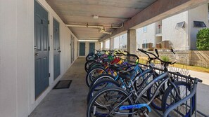 A covered bike parking area with multiple bicycles and a concrete floor. - Gulf-Front & Amazing Views in this Updated Condo + Free Attraction Tickets! (Santa Rosa Beach)