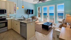 A spacious kitchen with a central island, a dining area with a view of the ocean, and a cozy seating area with a view of the beach. - Gulf Front in Seagrove ~ Amazing Views + Free Attraction Tickets! (Santa Rosa Beach)