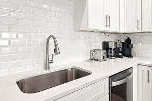 A modern kitchen with a stainless steel sink, a coffee maker, and a toaster. - Gulf Front - Seagrove Beach + Free Attraction Tickets! (Santa Rosa Beach)