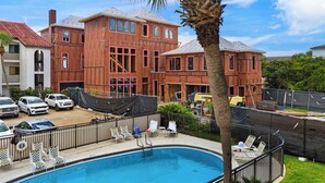 A residential building with a swimming pool, multiple cars, and construction materials visible. - Seagrove Beach | Gulf Side + Free Tickets: Bikes, Dolphin Cruise & More! (Santa Rosa Beach)