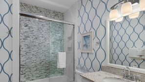 Combined shower/bathtub, towels, soap, shampoo