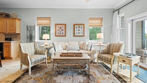 A living room with a sofa, armchairs, a coffee table, and a rug. - Coastal Condo for 6 w/ Pool, 6 Mins to the Beach + Free Attraction Tickets! (Santa Rosa Beach)