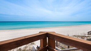 A wooden deck overlooking a beach with clear blue water and sandy shore. - Gulf Front, Steps to Beach, Sleeps 11 + Attraction Tickets! (Inlet Beach)