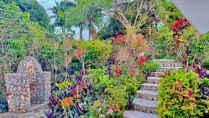 A stone staircase surrounded by lush tropical plants and a stone wall. - Shell House, Dominican Caracol with 14m Pool and Ocean view (Cabrera Maria Trinidad Sanchez)