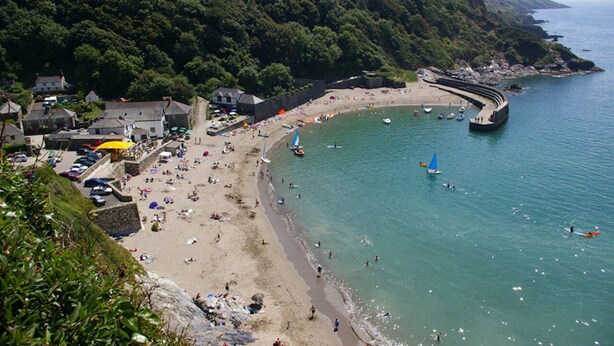 A coastal town with a sandy beach, boats, and a forested hill. - NEW 2021, Idyllic Cottage in Polkerris,  by the beach, sea views, near Fowey. (Par)