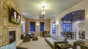 A spacious living area with a fireplace, comfortable seating, and a dining area.
